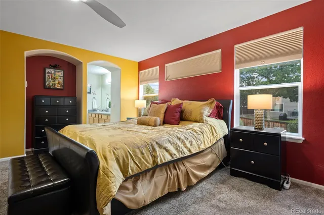 a bedroom with a bed and a dresser next to a window