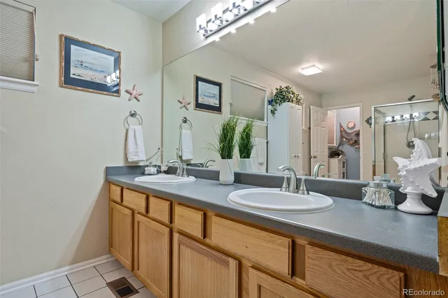 a bathroom with a sink double vanity granite and a mirror