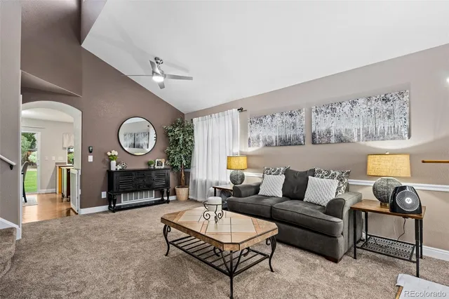 a living room with furniture a rug and a window