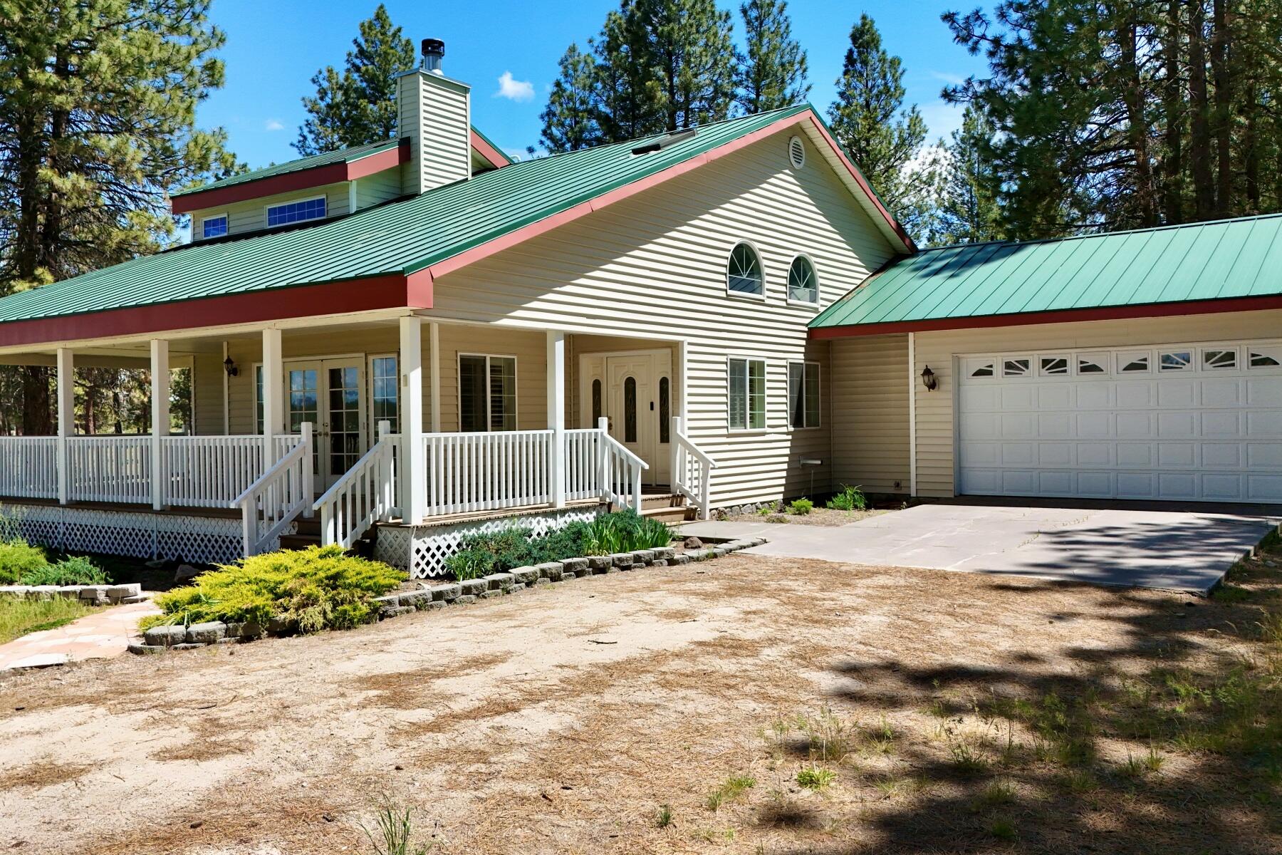 25210 Sprague River Road Sprague River, OR 97639 - Photo 2 of 79 a front view of a house with a garden and entryway