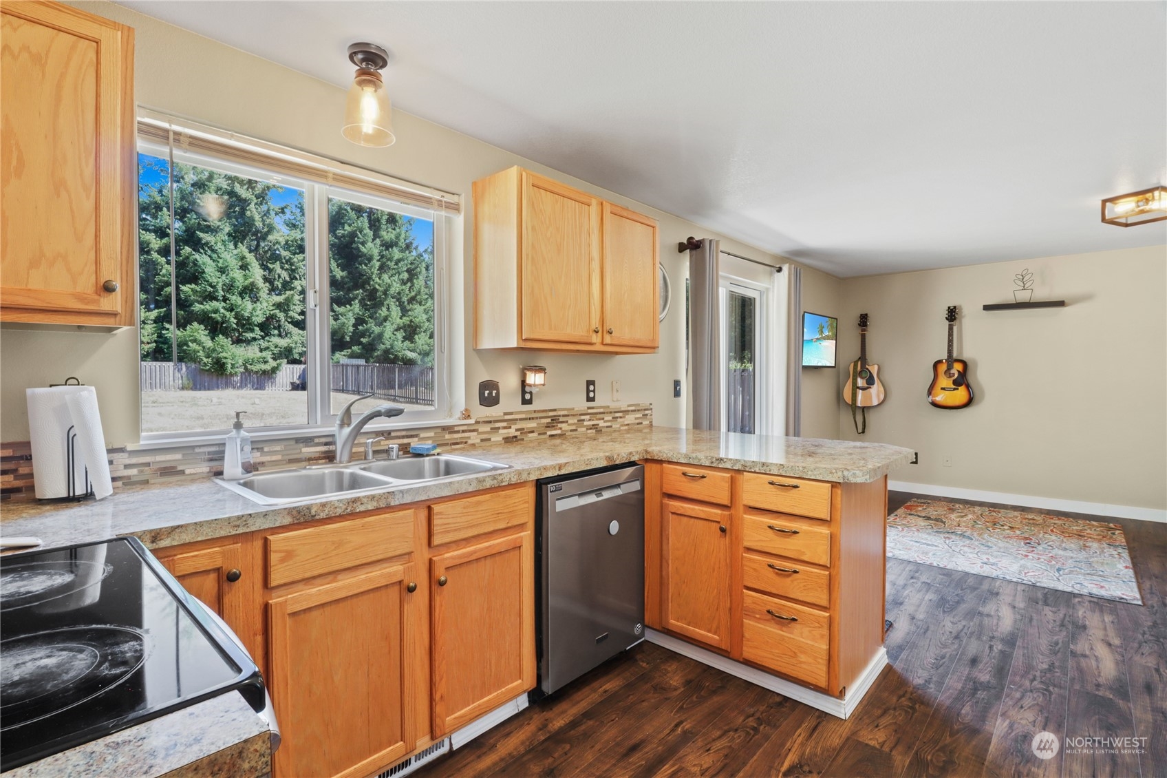 5412 187th Court Southwest Rochester, WA 98579 - Photo 11 of 37 a kitchen with stainless steel appliances granite countertop a sink stove and cabinets