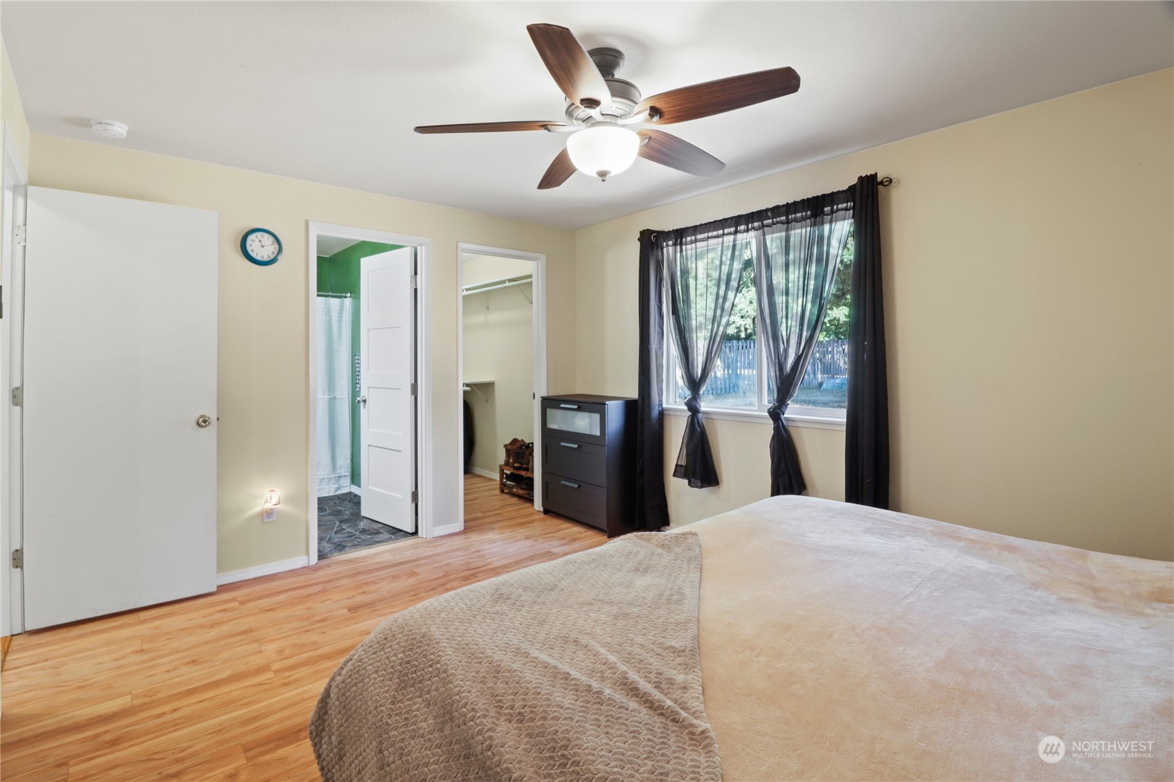 5412 187th Court Southwest Rochester, WA 98579 - Photo 18 of 37 a bedroom with a large bed and a large window