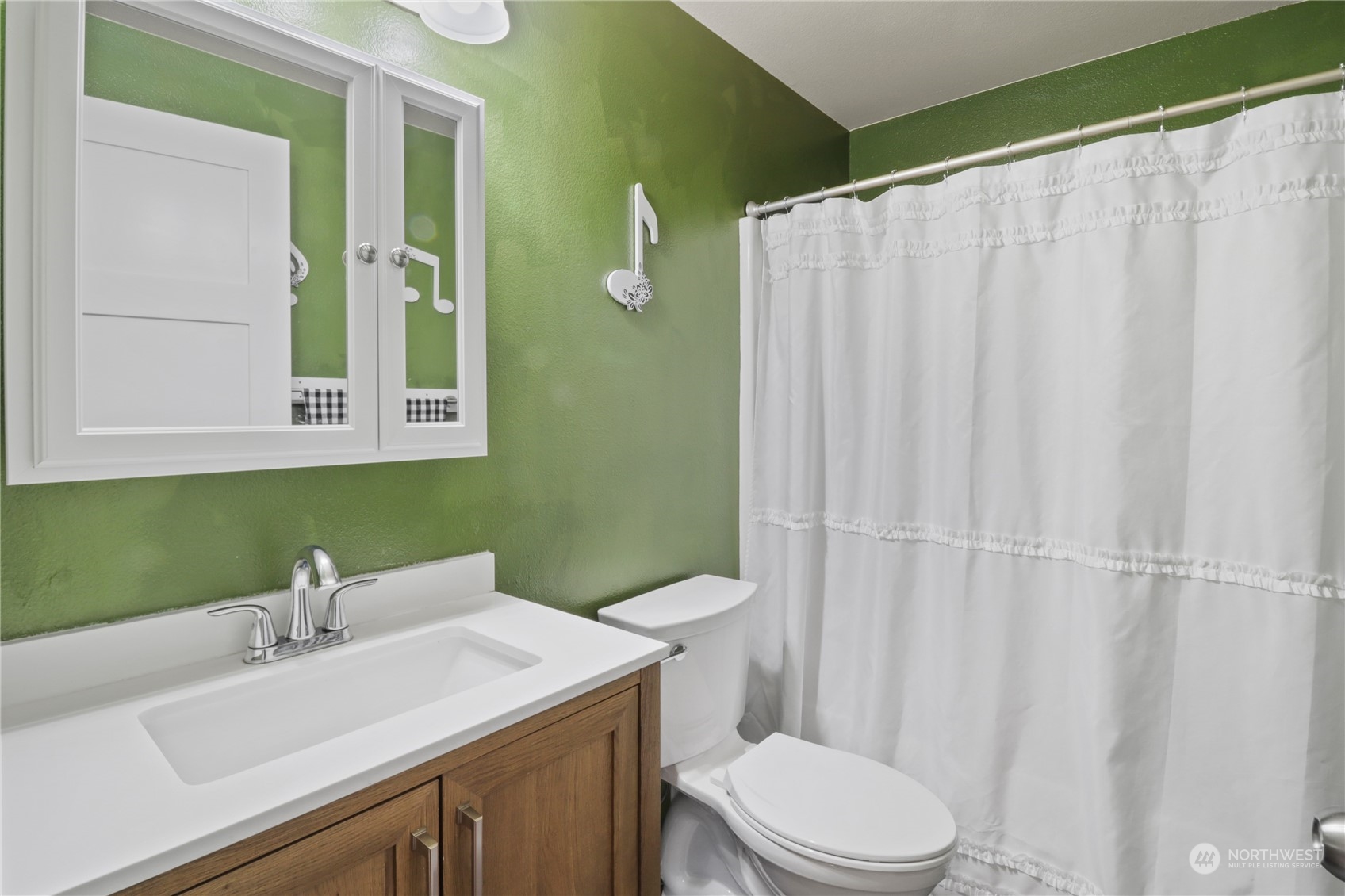 5412 187th Court Southwest Rochester, WA 98579 - Photo 19 of 37 a bathroom with a sink a toilet and shower curtain
