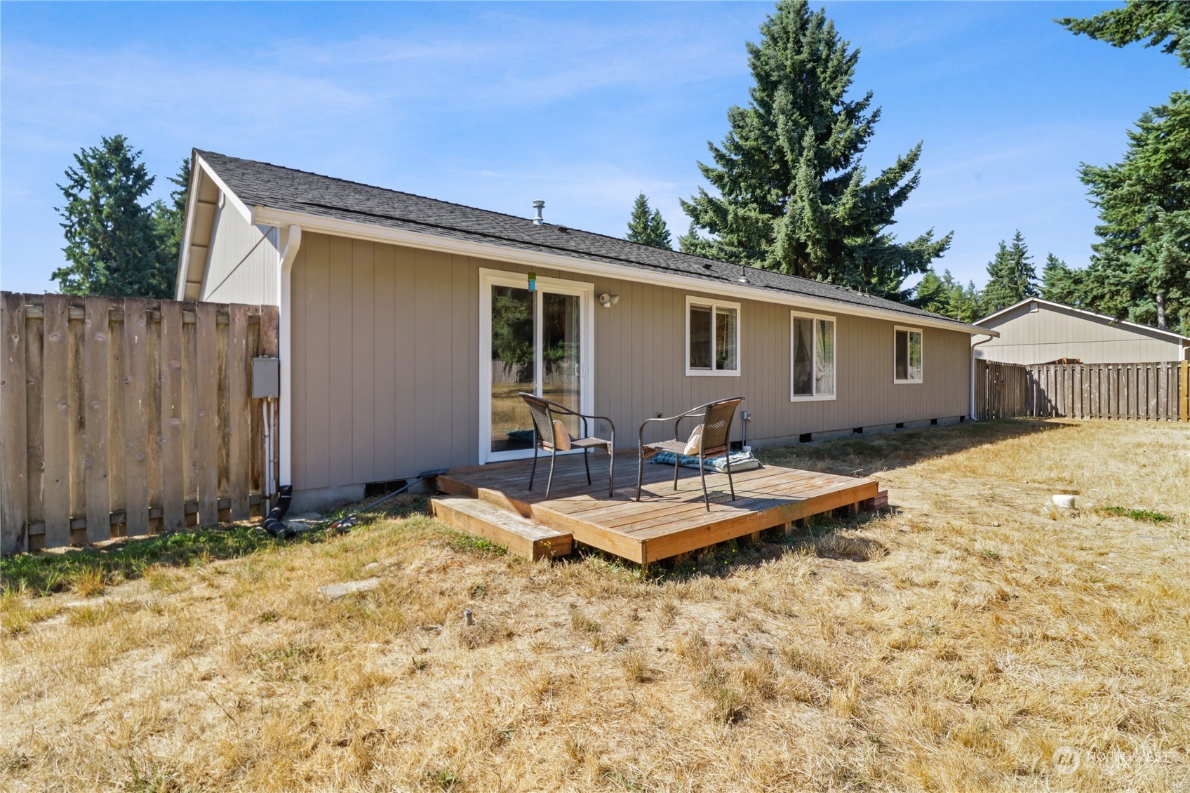 5412 187th Court Southwest Rochester, WA 98579 - Photo 29 of 37 a backyard of a house with table and chairs
