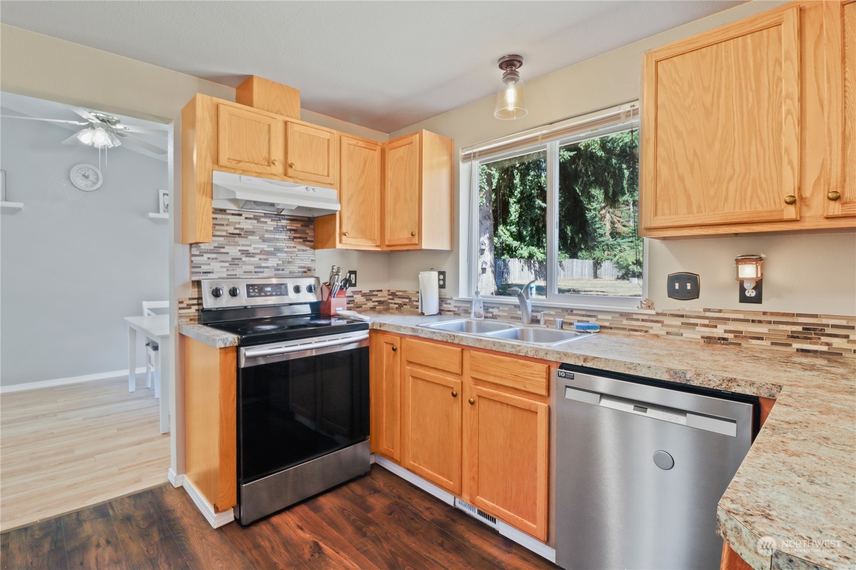 5412 187th Court Southwest Rochester, WA 98579 - Photo 10 of 37 a kitchen with stainless steel appliances granite countertop a stove and a sink