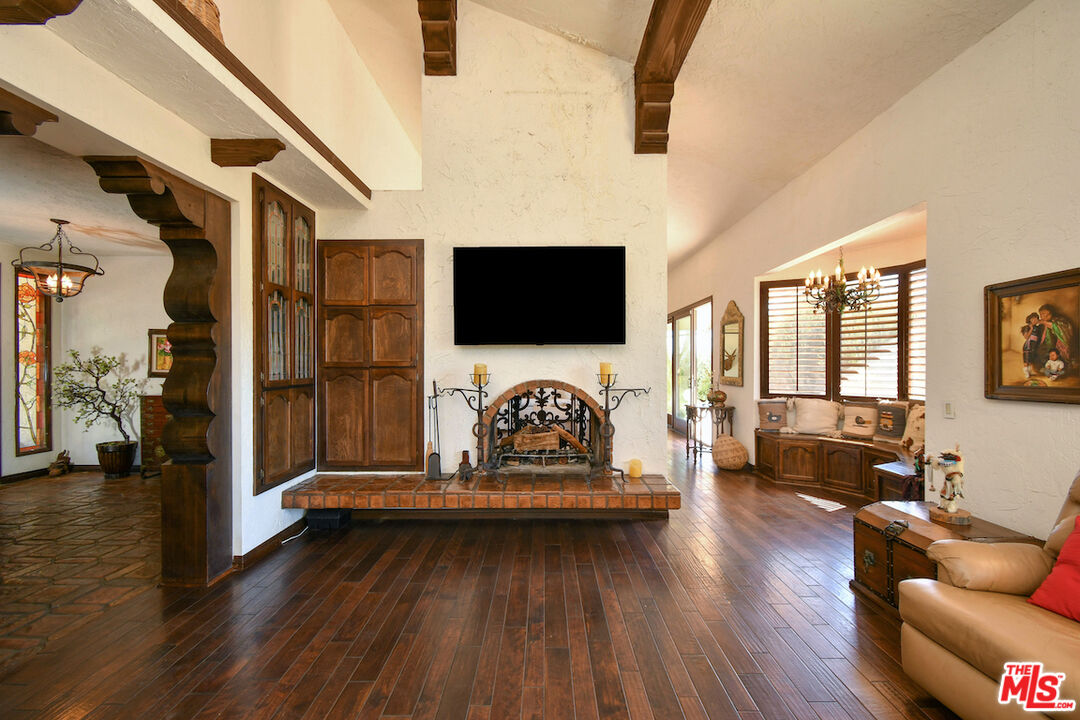 24926 Jim Bridger Road Hidden Hills, CA 91302 - Photo 6 of 44 a living room with furniture and a flat screen tv