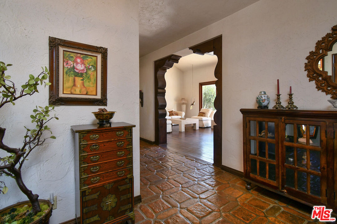 24926 Jim Bridger Road Hidden Hills, CA 91302 - Photo 10 of 40 a view of a bedroom with furniture and staircase