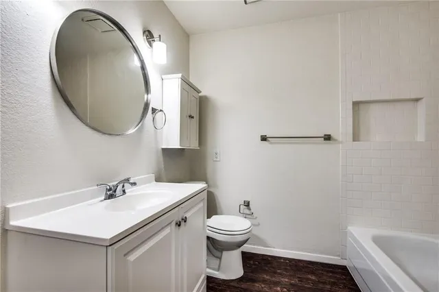 a bathroom with a sink toilet and a mirror