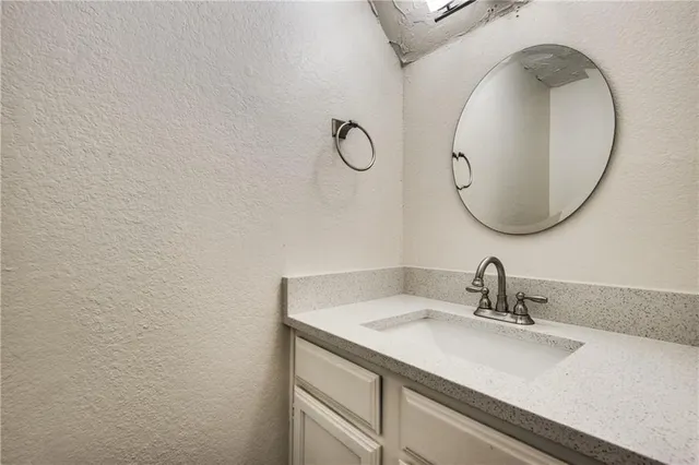 a bathroom with a sink and mirror
