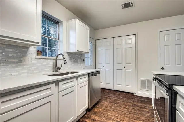 a kitchen with a sink and cabinets
