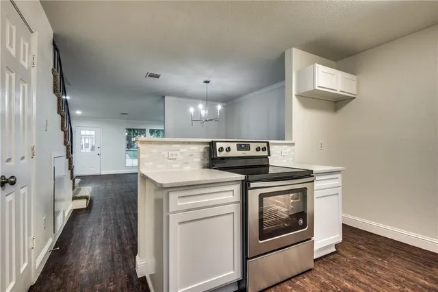 a view of a kitchen with a stove top oven