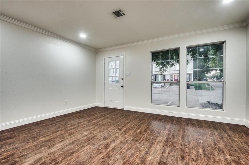 35 Abbey Road Euless, TX 76039 - Photo 24 of 25 an empty room with wooden floor and windows