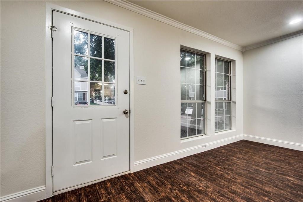 35 Abbey Road Euless, TX 76039 - Photo 25 of 25 an empty room with wooden floor and windows