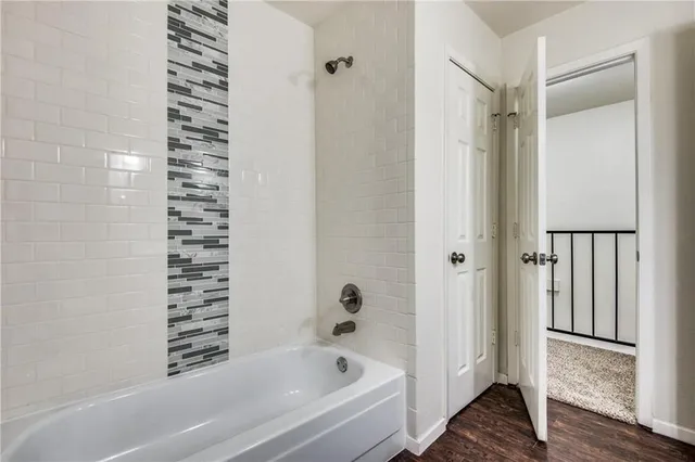 a bathroom with bathtub and shower