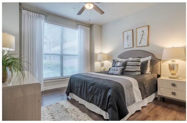 a bedroom with a bed and a potted plant
