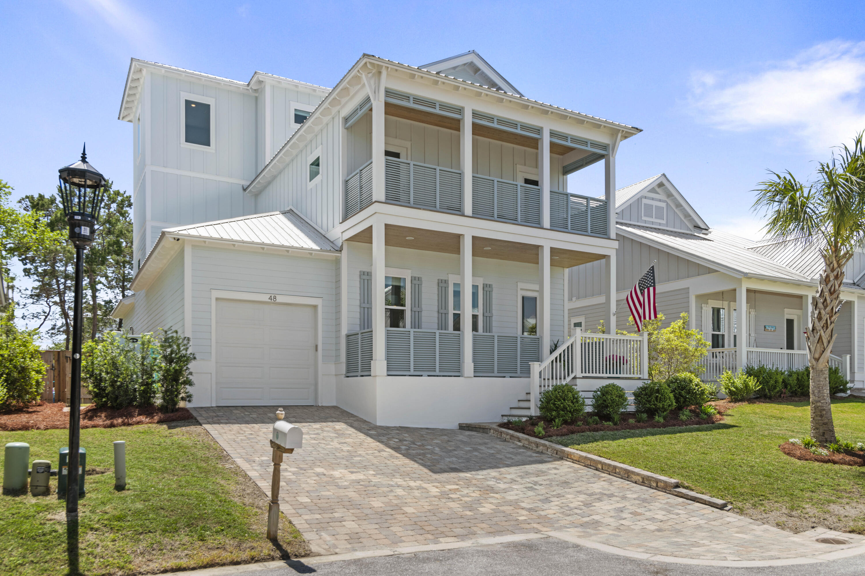 48 Lake Mist Ln Inlet Beach Inlet Beach, FL 32461 - Photo 1 of 78 a front view of a house with a yard and trees