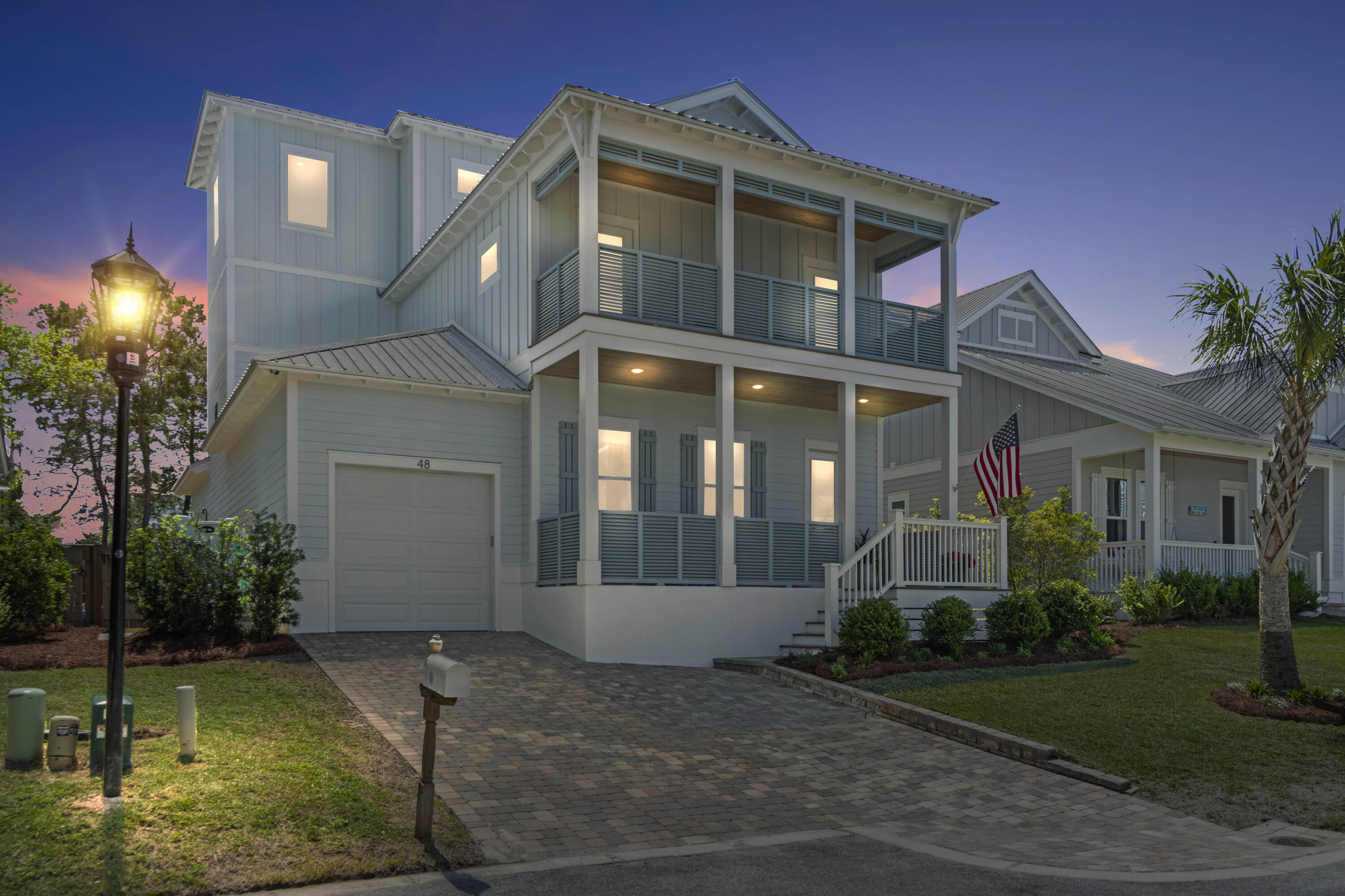 48 Lake Mist Ln Inlet Beach Inlet Beach, FL 32461 - Photo 2 of 78 a front view of a house with a yard and porch