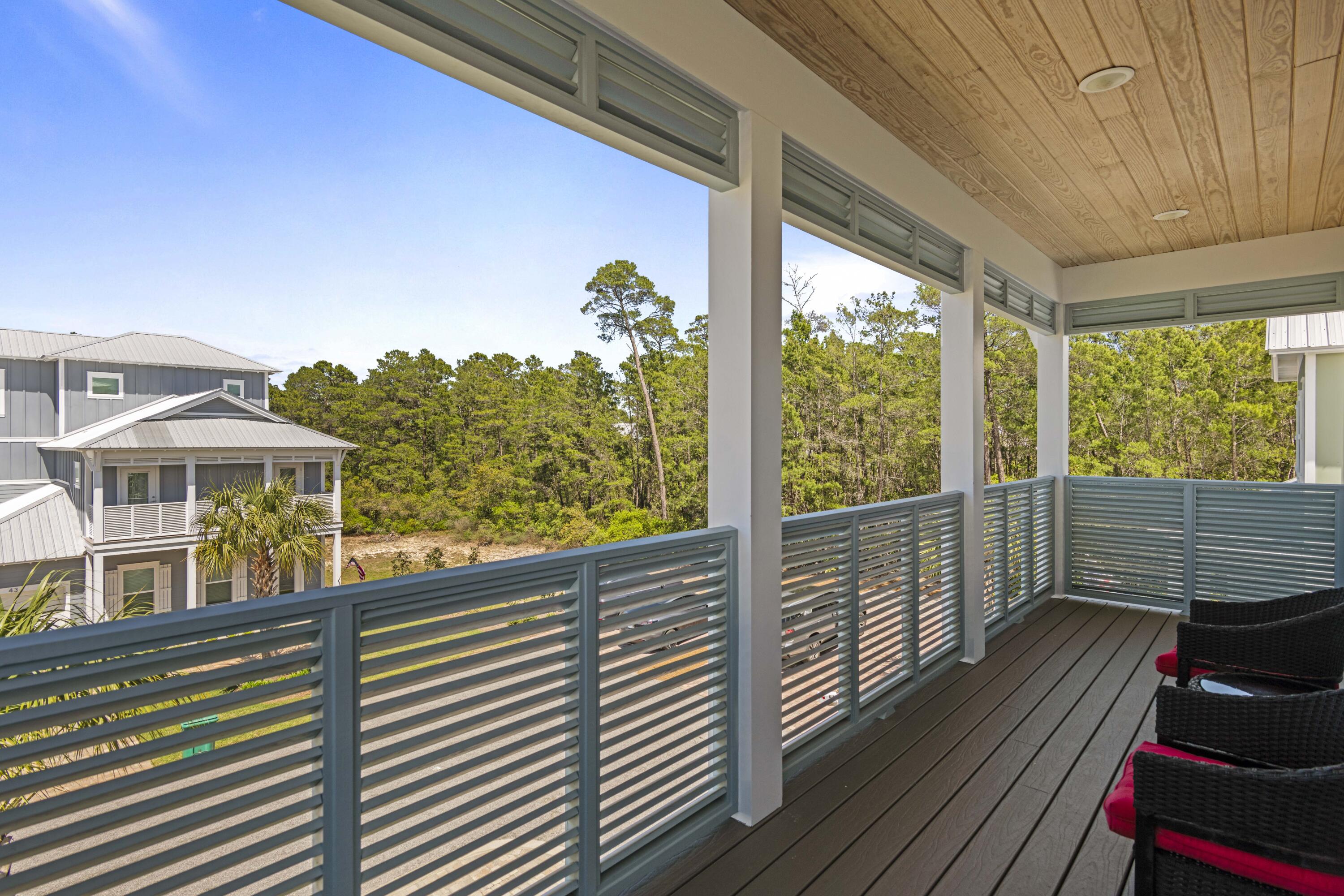 48 Lake Mist Ln Inlet Beach Inlet Beach, FL 32461 - Photo 36 of 78 a view of a balcony with floor to ceiling windows with wooden floor