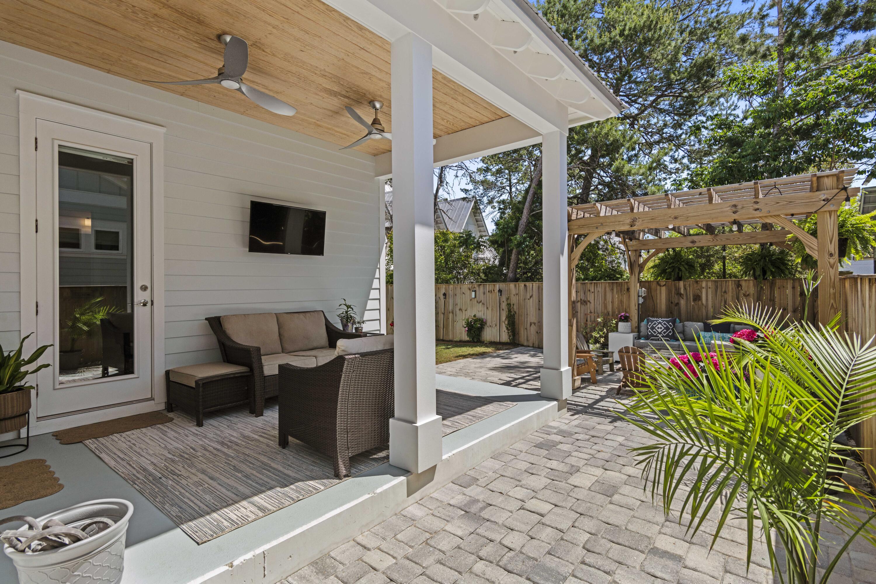48 Lake Mist Ln Inlet Beach Inlet Beach, FL 32461 - Photo 47 of 78 a view of a patio with couches table and chairs and potted plants