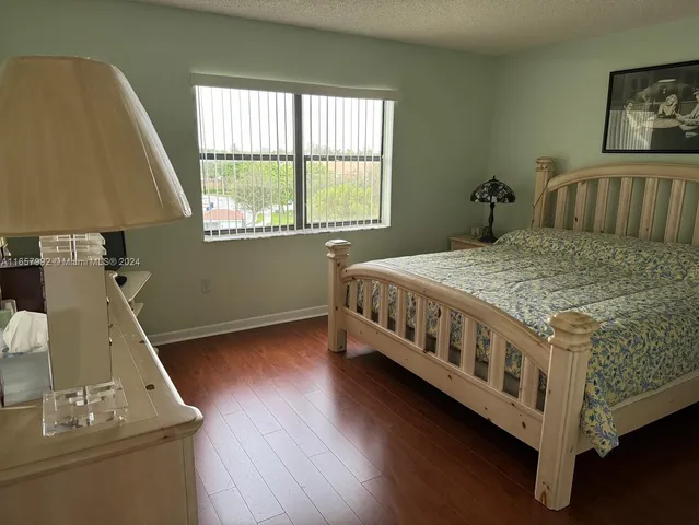 a bedroom with a bed next to a window