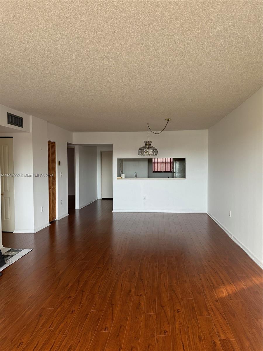 10253 Northwest 9th St Circle, Unit 4076 Miami, FL 33172 - Photo 7 of 11 a view of a kitchen with a dishwasher and wooden floor