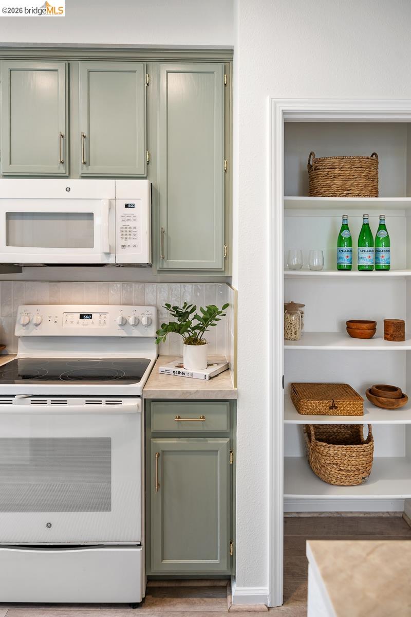 2029 Channing Way, Unit 3D Berkeley, CA 94704 - Photo 24 of 54 Kitchen featuring sage green cabinetry, white appliances, and a built-in microwave