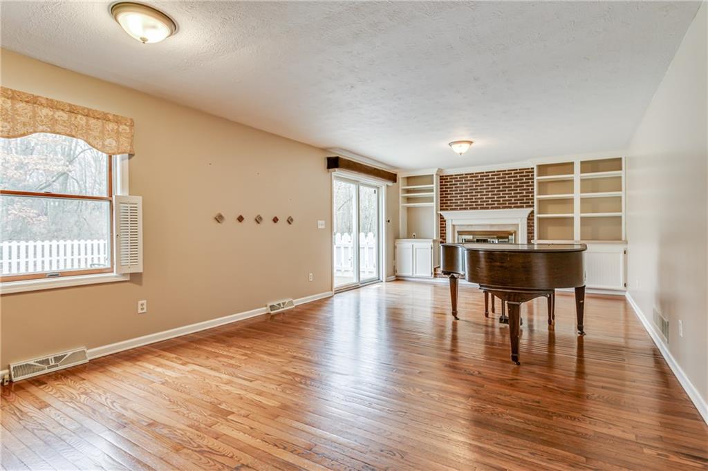 148 Mary Reed Road Baden, PA 15005 - Photo 7 of 25 Family room leads to back patio and yard. Beautiful hardwood floors found in the 25x13 family room and kitchen.