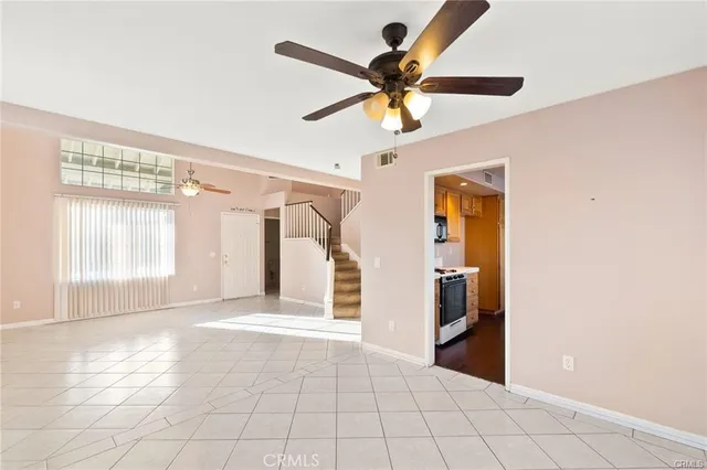 a view of a livingroom with a ceiling fan and window