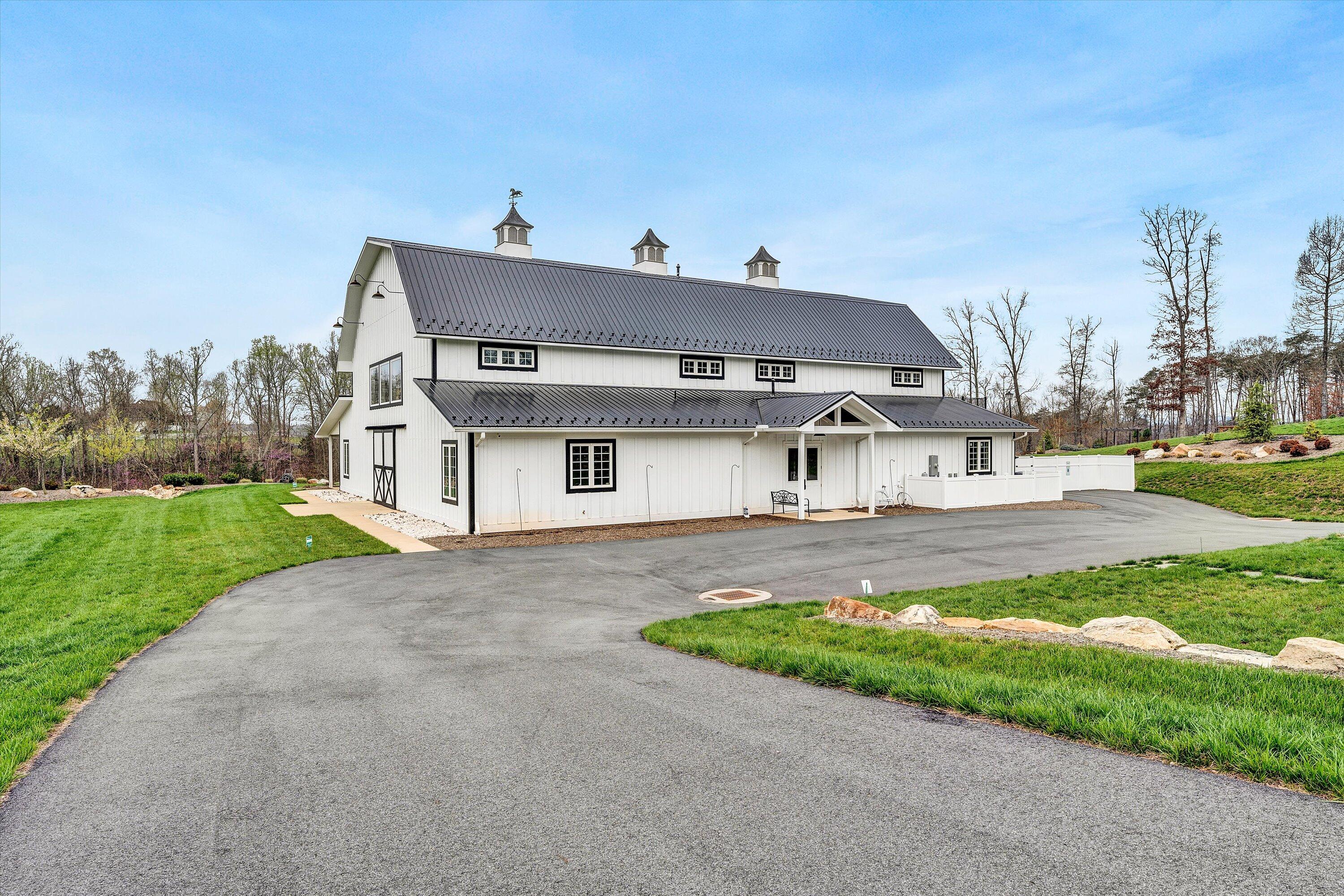 9945 Brooks Mill Road Wirtz, VA 24184 - Photo 35 of 50 a front view of a house with a yard and garage