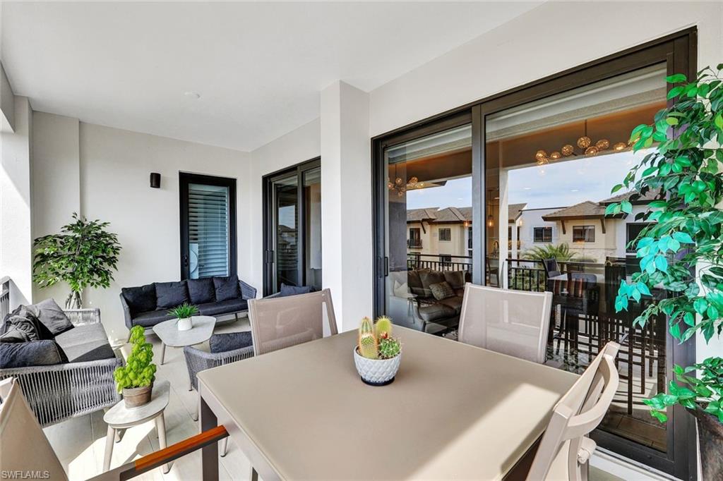 1035 3rd Avenue South, Unit 514 Naples, FL 34102 - Photo 13 of 35 a view of a dining room with furniture window and wooden floor