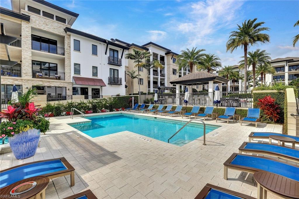 1035 3rd Avenue South, Unit 514 Naples, FL 34102 - Photo 25 of 35 a front view of multiple houses with swimming pool and seating