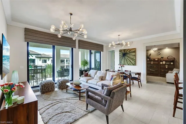 a living room with furniture and a chandelier