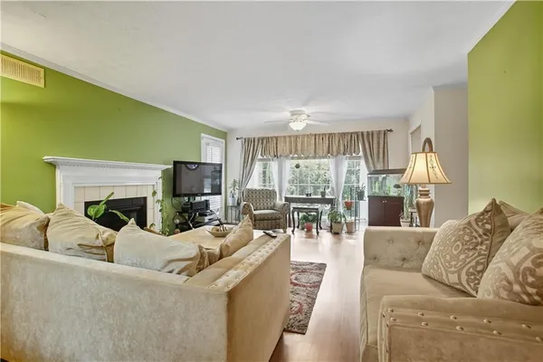 a living room with furniture a fireplace and a flat screen tv