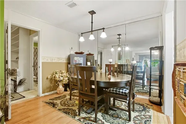 a dining room with furniture and wooden floor