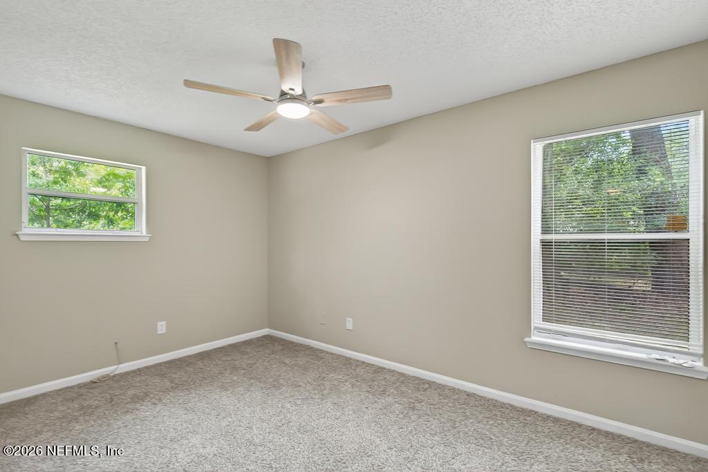2080 Tuskegee Road Jacksonville, FL 32209 - Photo 11 of 23 an empty room with windows and fan