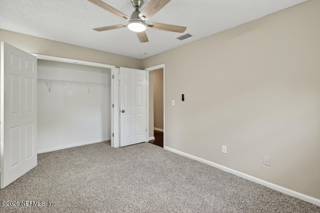2080 Tuskegee Road Jacksonville, FL 32209 - Photo 12 of 23 an empty room with a ceiling fan and a window