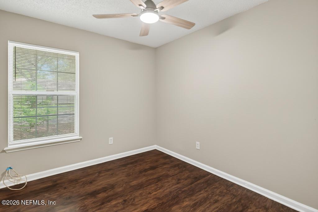 2080 Tuskegee Road Jacksonville, FL 32209 - Photo 17 of 23 an empty room with wooden floor and windows