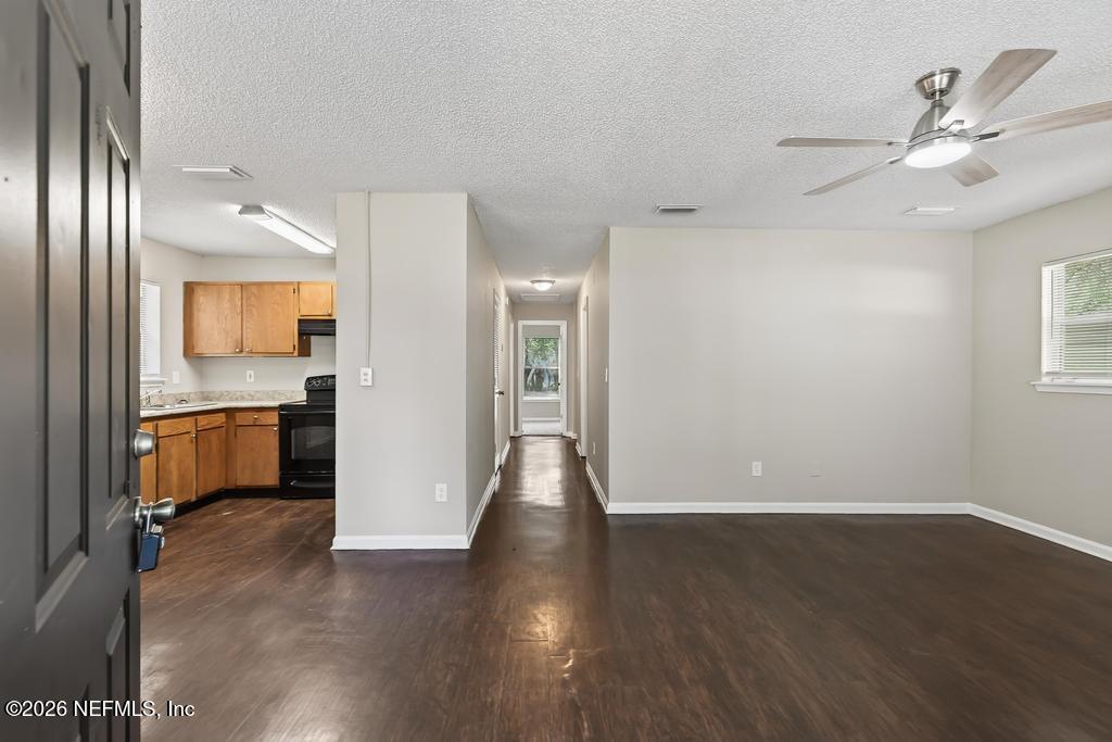 2080 Tuskegee Road Jacksonville, FL 32209 - Photo 3 of 23 a view of a hallway with wooden floor and a kitchen