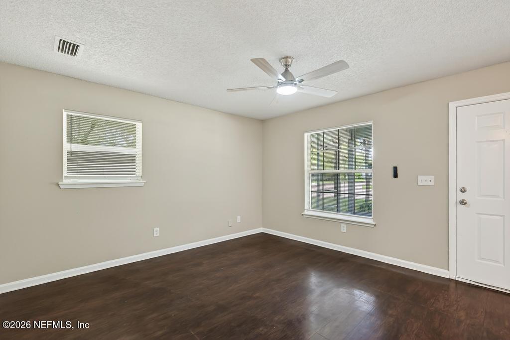 2080 Tuskegee Road Jacksonville, FL 32209 - Photo 6 of 23 a view of an empty room with a window and wooden floor