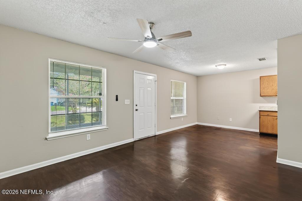 2080 Tuskegee Road Jacksonville, FL 32209 - Photo 7 of 23 a view of an empty room with a window and wooden floor