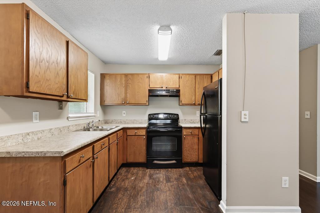 2080 Tuskegee Road Jacksonville, FL 32209 - Photo 9 of 23 a kitchen with stainless steel appliances granite countertop a sink stove and refrigerator