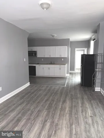 a view of kitchen with cabinets and wooden floor