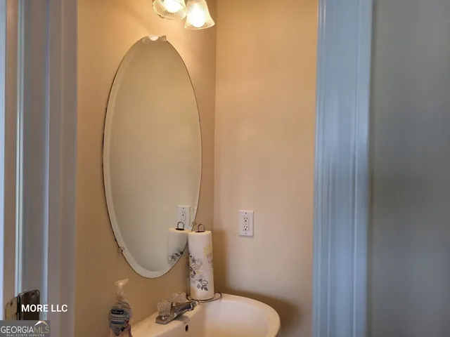 a bathroom with a sink mirror and toilet