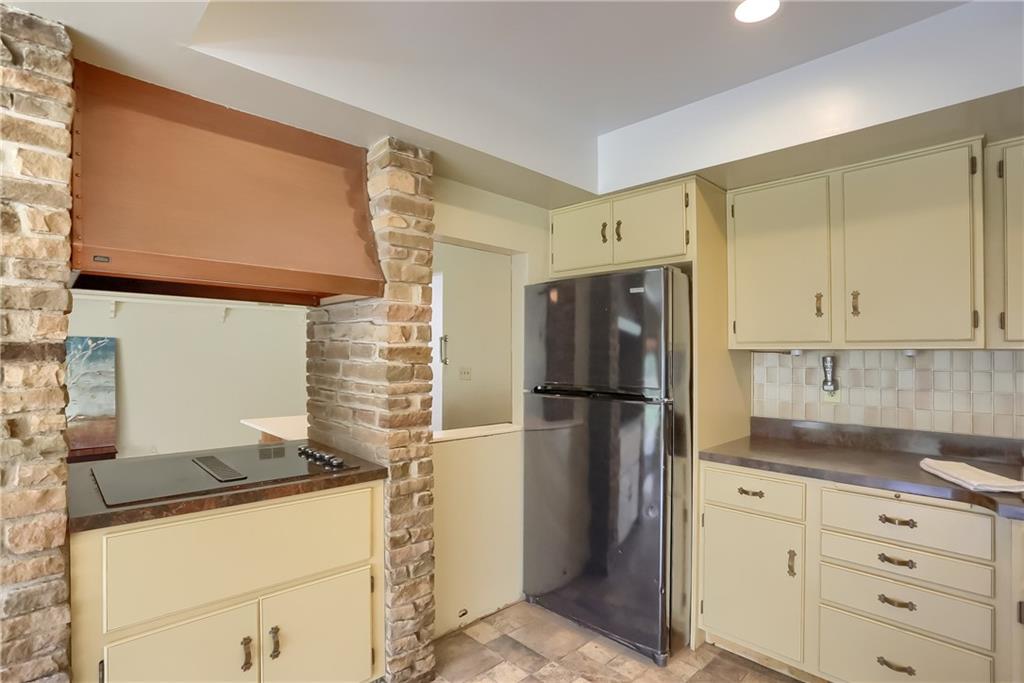 566 Zeigler Road Rochester, PA 15074 - Photo 26 of 50 a kitchen with stainless steel appliances granite countertop a refrigerator a stove and white cabinets with wooden floor