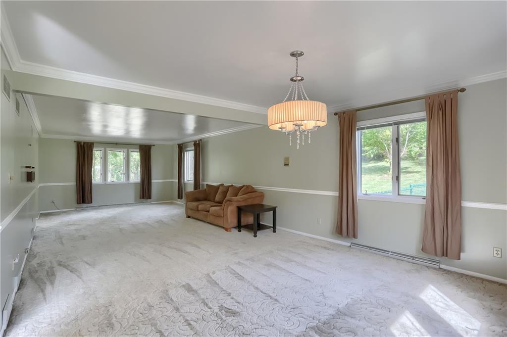 566 Zeigler Road Rochester, PA 15074 - Photo 30 of 50 a living room with furniture and a chandelier