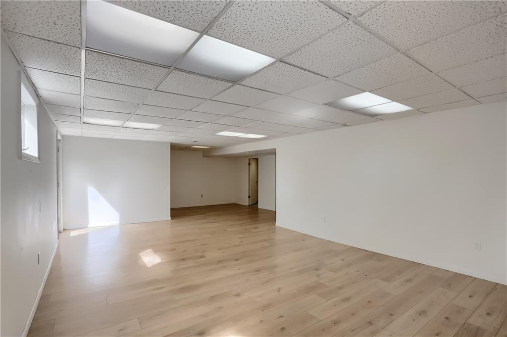 566 Zeigler Road Rochester, PA 15074 - Photo 44 of 50 an empty room with wooden floor and natural light
