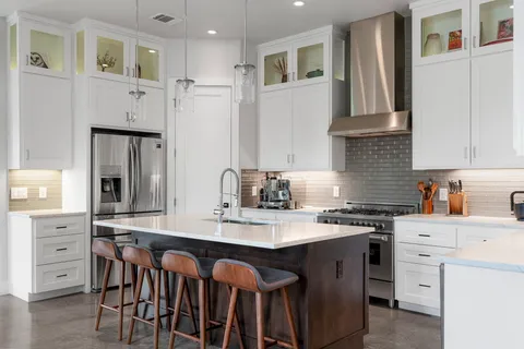 a kitchen with stainless steel appliances granite countertop a sink stove and cabinets