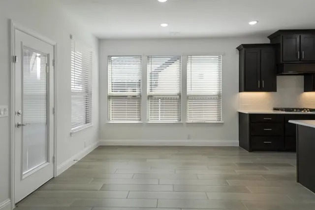a view of kitchen with windows and refrigerator