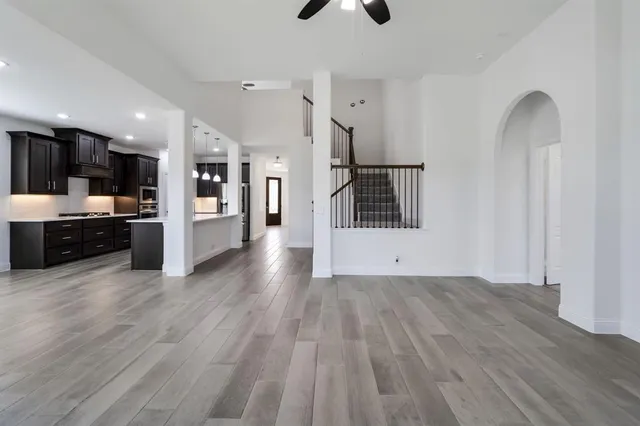 a view of a kitchen with microwave and refrigerator