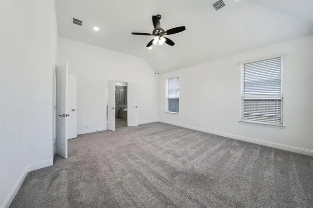 a view of an empty room with a ceiling fan